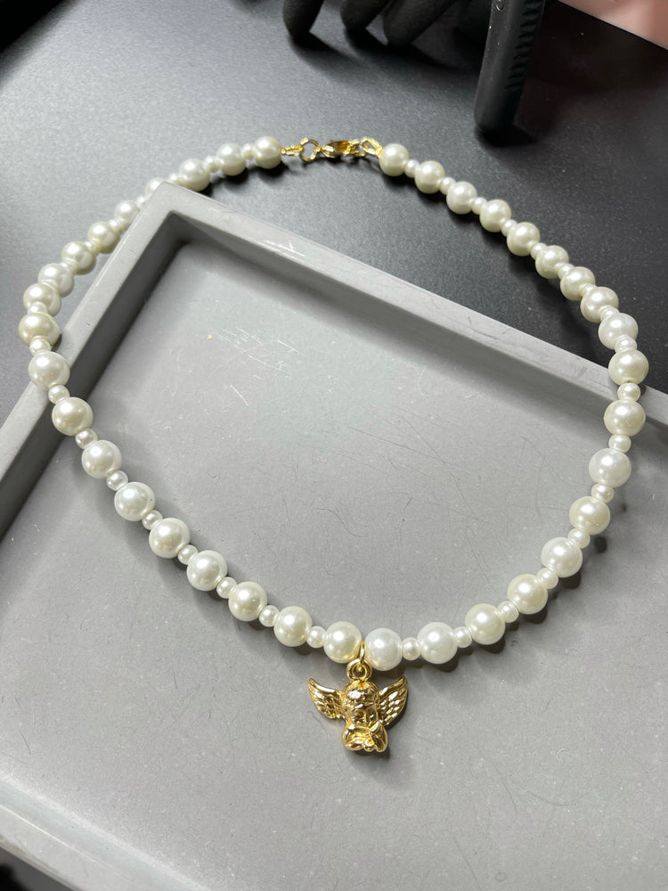 
                  
                    The Angel Pearl Necklace
                  
                